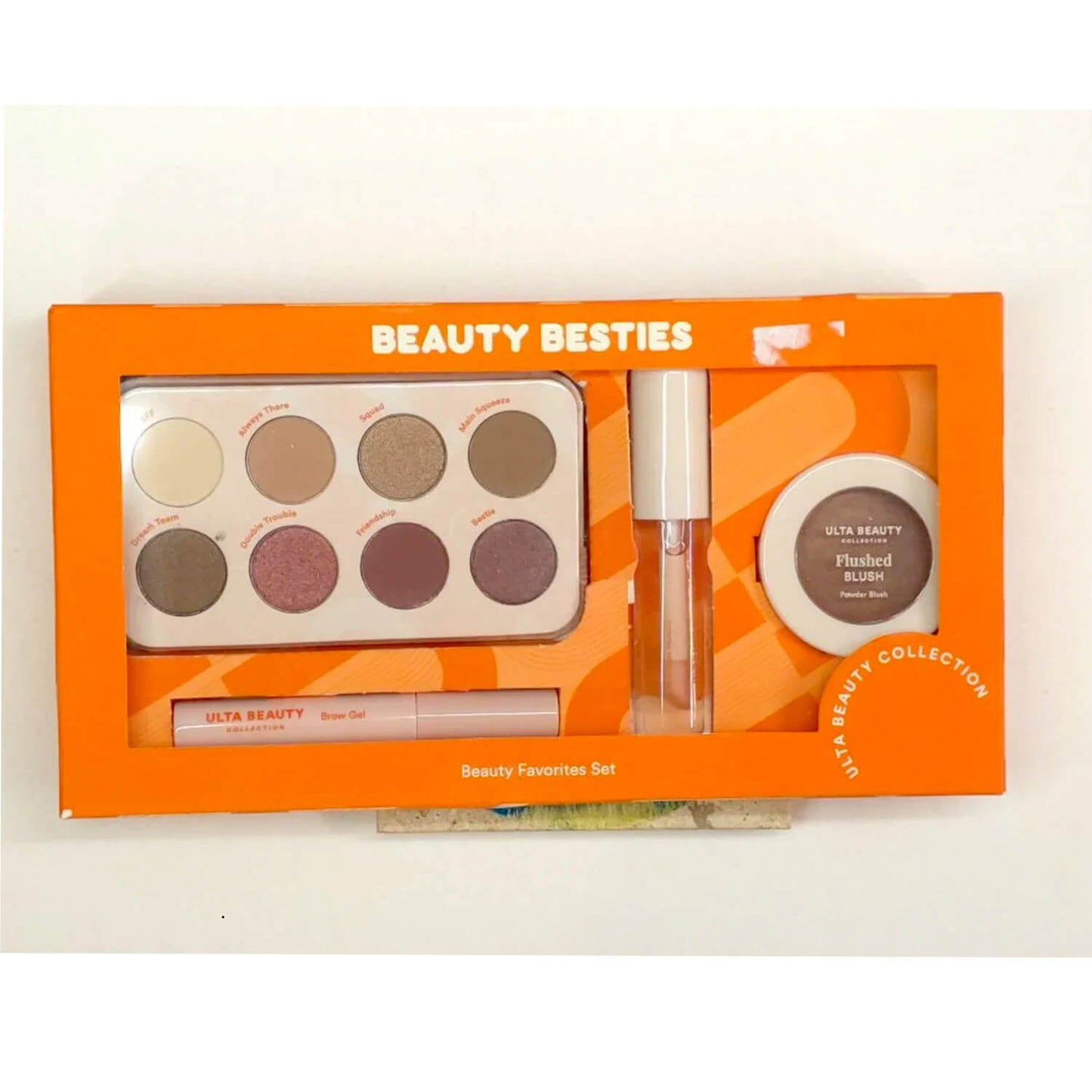 Ulta Beauty Besties Beauty Favorites Set in its orange packaging, containing a 9-shade eyeshadow palette, a lip gloss, and a flushed blush compact.