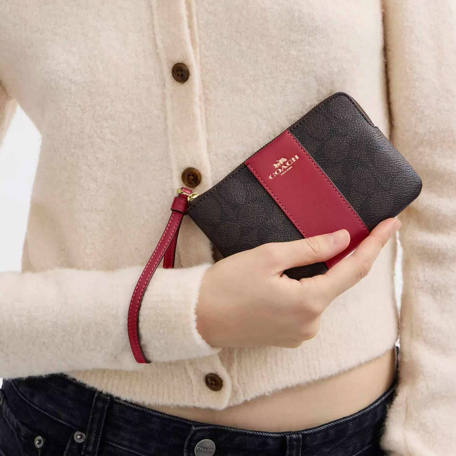 image showing girl with coach wristlet for her available at Heygirl.pk for delivery in Pakistan