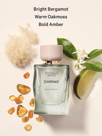 Victoria's Secret Daring perfume bottle with bergamot, oakmoss, and amber elements on a light background