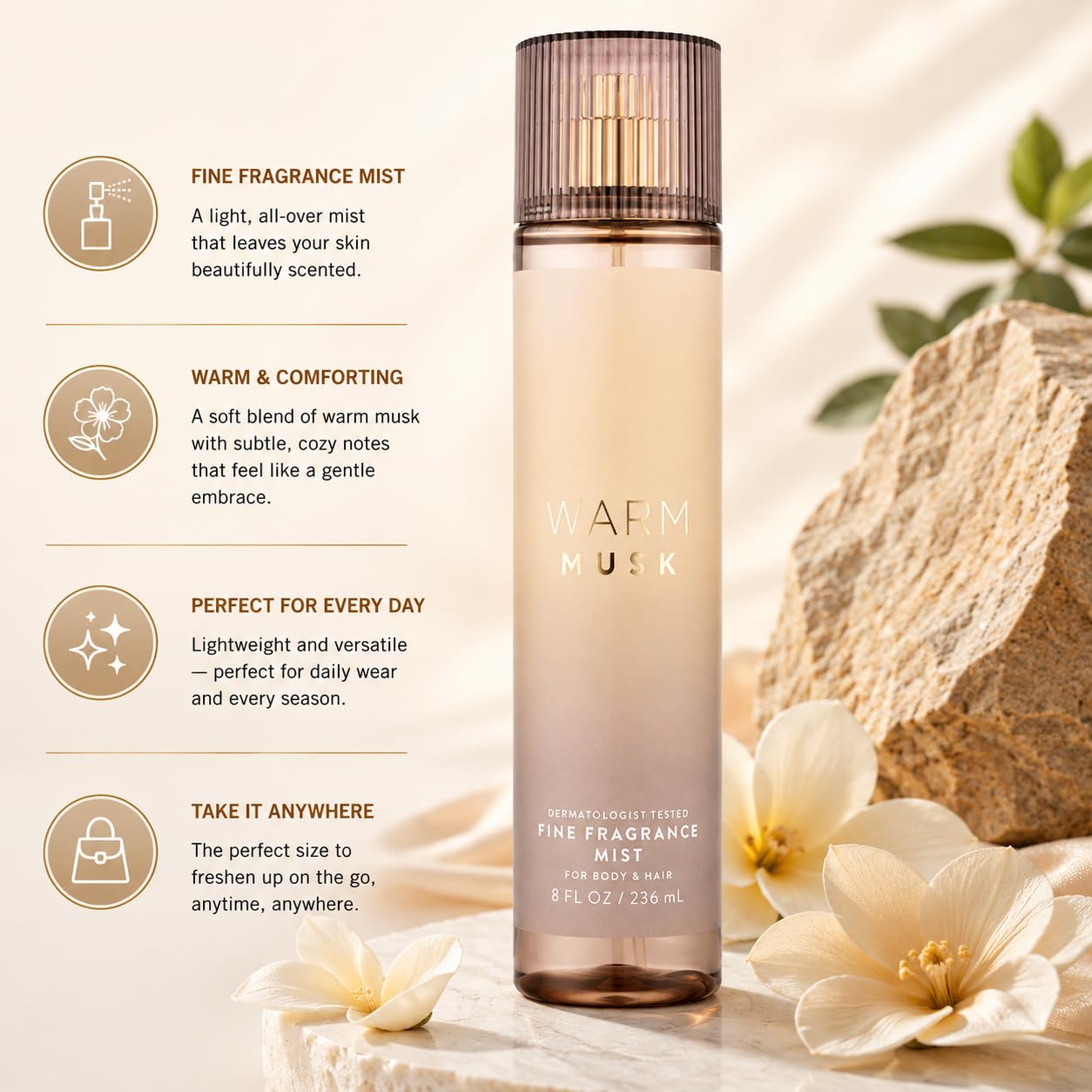 A bottle of Warm Musk Fine Fragrance Mist stands upright on a light beige surface with decorative white flowers and a rock in the background. On the left are four circular text callouts describing the fragrance mist features.