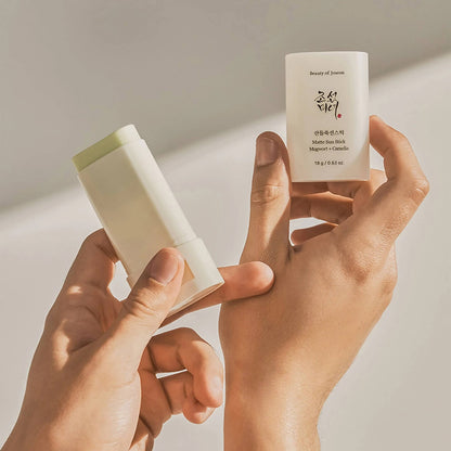 image showing Joseon Relief Matte Sunblock stick in the hands of a Pakistani girl available at Heygirl.pk for delivery in Pakistan. 