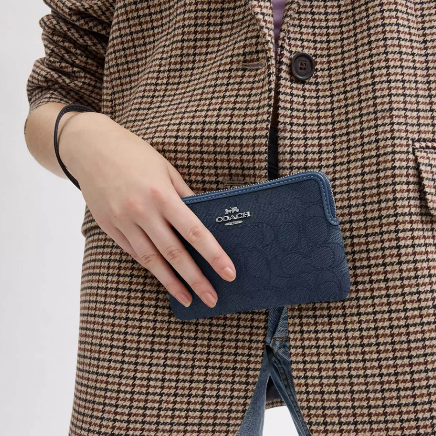 image showing girl with coach wristlet for her available at Heygirl.pk for delivery in Pakistan
