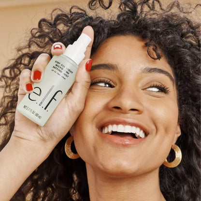 Woman holding a bottle of e.l.f. cosmetic product with a warm background in Pakistan