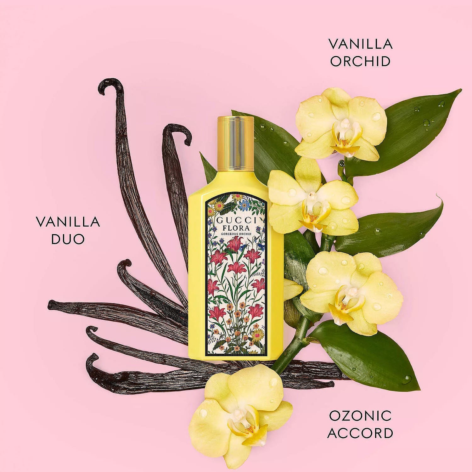 Gucci Flora Vanilla Orchid perfume bottle with vanilla beans and flowers on a pink background