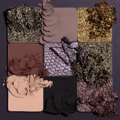 Makeup palette with various shades of eyeshadow on a dark background
