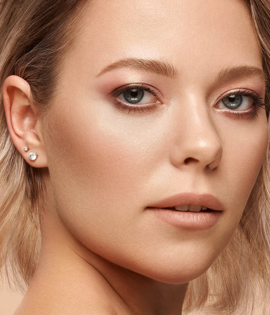 Close-up of a woman's face with a focus on her eye and ear.