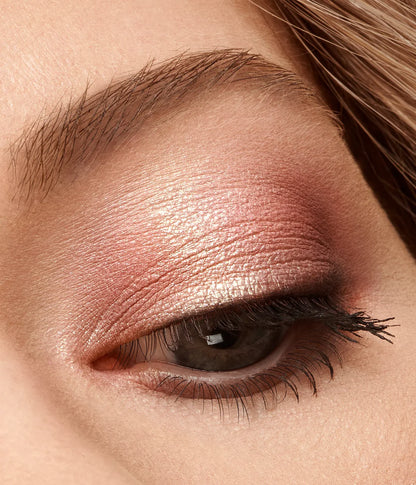 Close-up of a woman's eye with pink eyeshadow