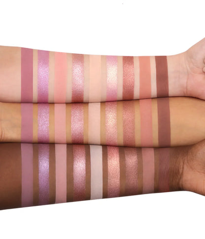 Color swatches on a person's arm with various shades of pink, purple, and brown.