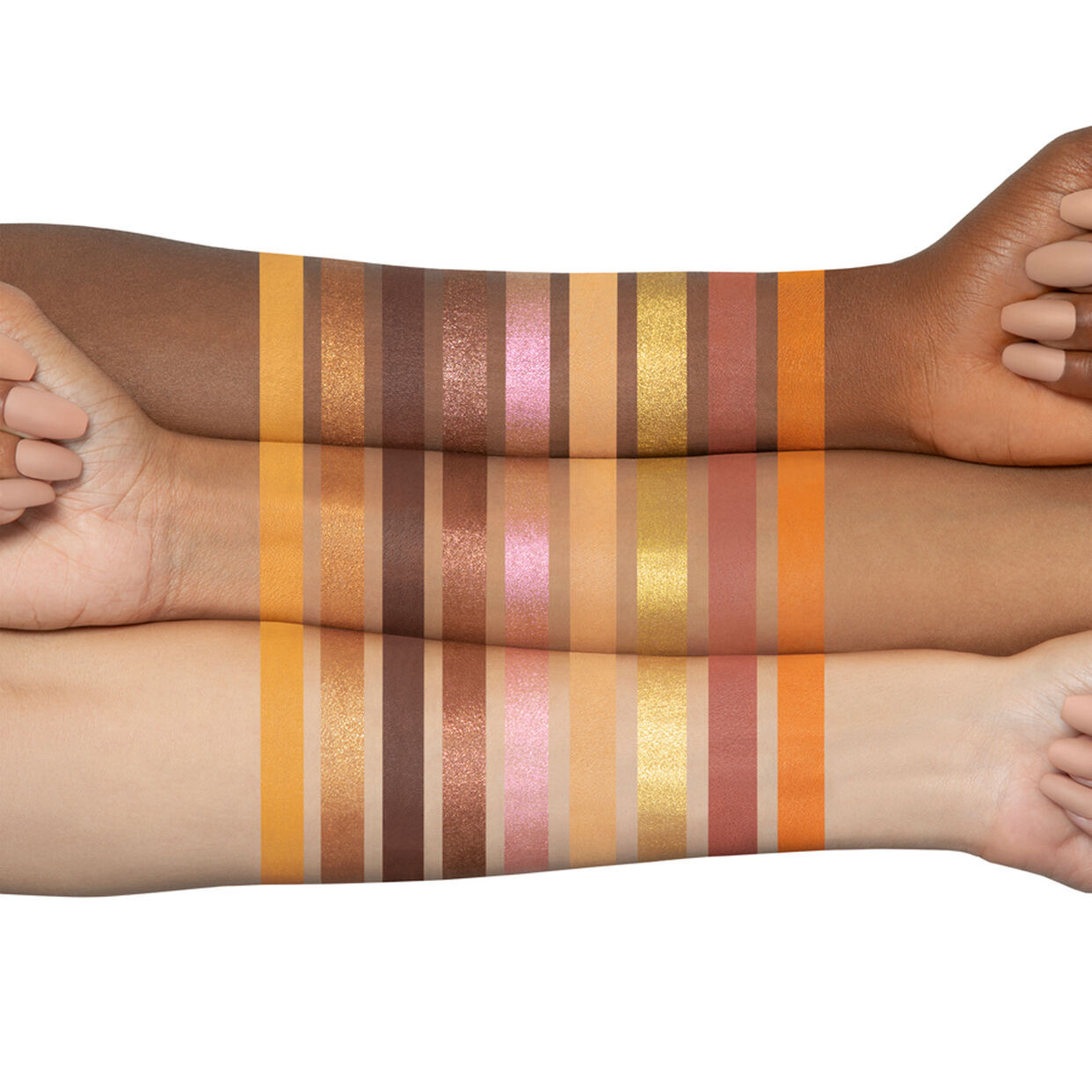Two arms with swatches of colorful makeup products on a white background