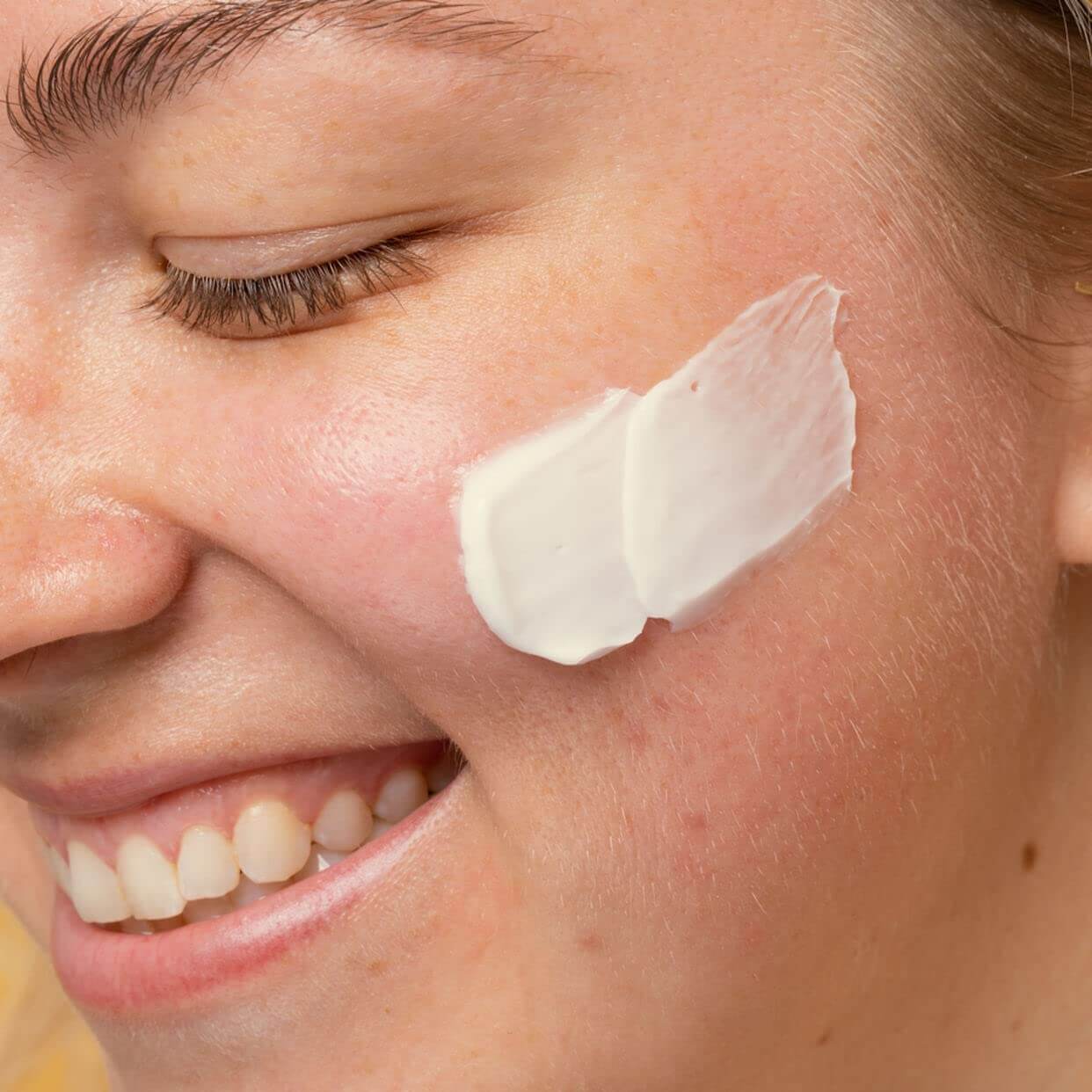 Close-up of a person applying cream to their face in Pakistan
