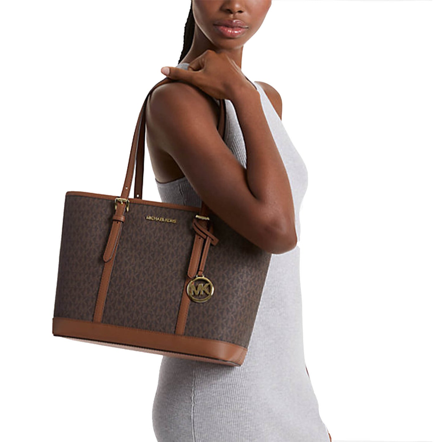 A Pakistani girl holding Michael Kors Jet Set Tote bag in Black color for her available at Heygirl.pk for delivery in Pakistan.