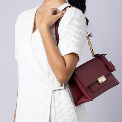 A pakistani girl holding michael kors shoulder bag in dark cherry color for her available at Heygirl.pk for delivery in Pakistan