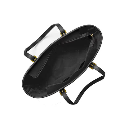 Black leather handbag shown from an overhead angle, displaying its spacious interior, quilted black lining, and gold-tone hardware on a solid white background.
