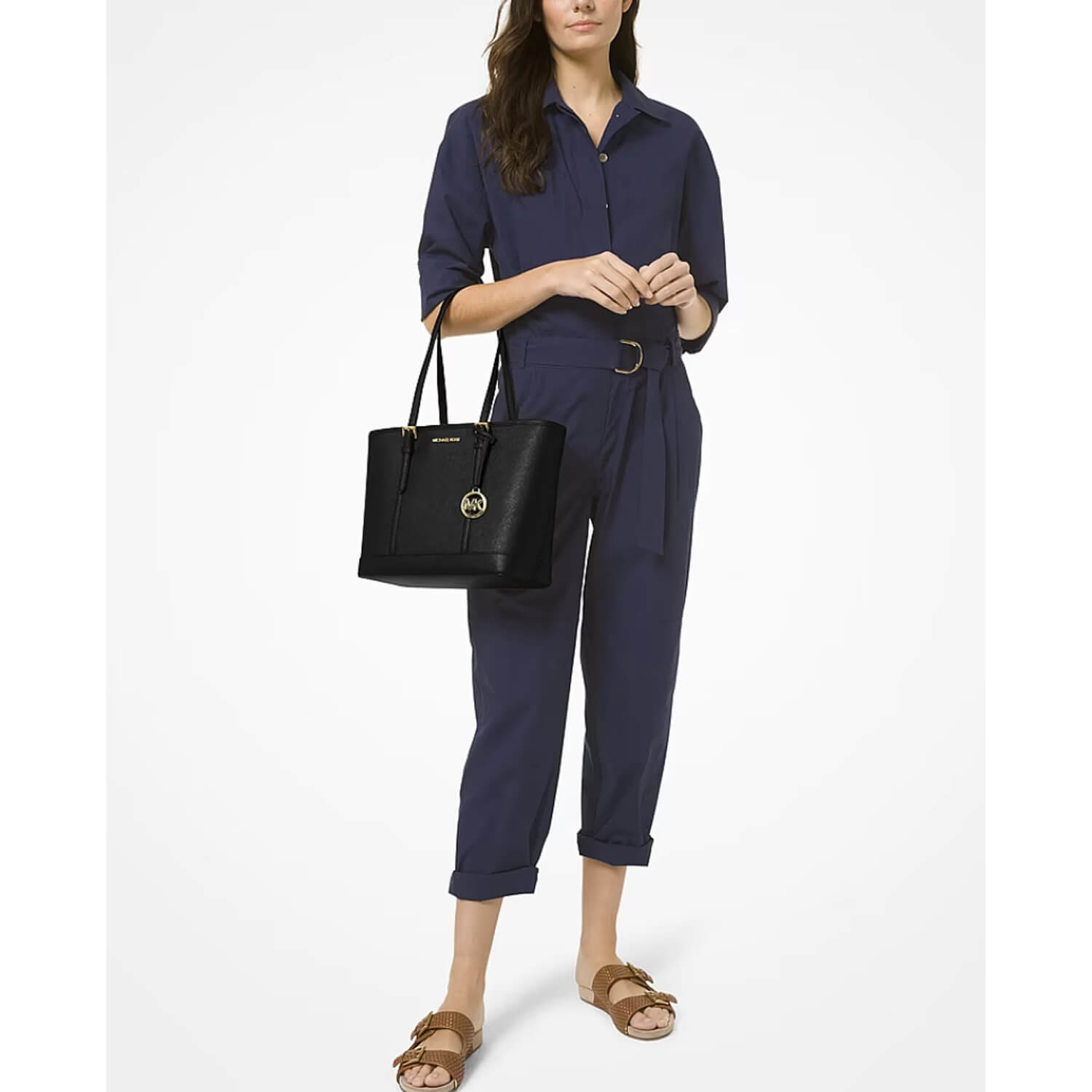 A model holding a black MK leather tote bag available at Heygirl.pk in Pakistan