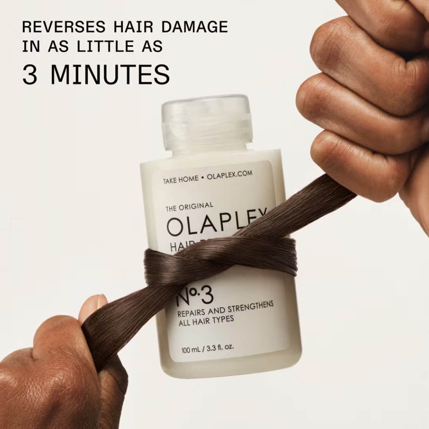 Olaplex hair treatment bottle with a strand of hair wrapped around available at Heygirl.pk for delivery in Pakistan