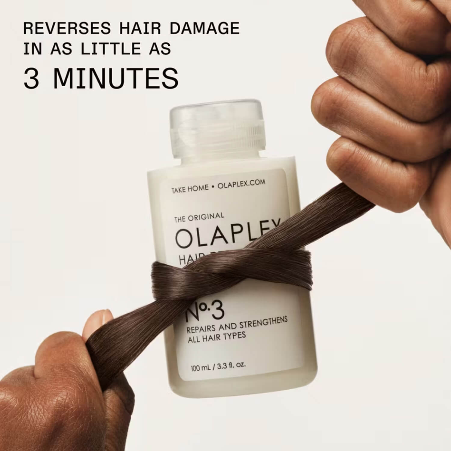 Olaplex hair treatment bottle with a strand of hair wrapped around available at Heygirl.pk for delivery in Pakistan