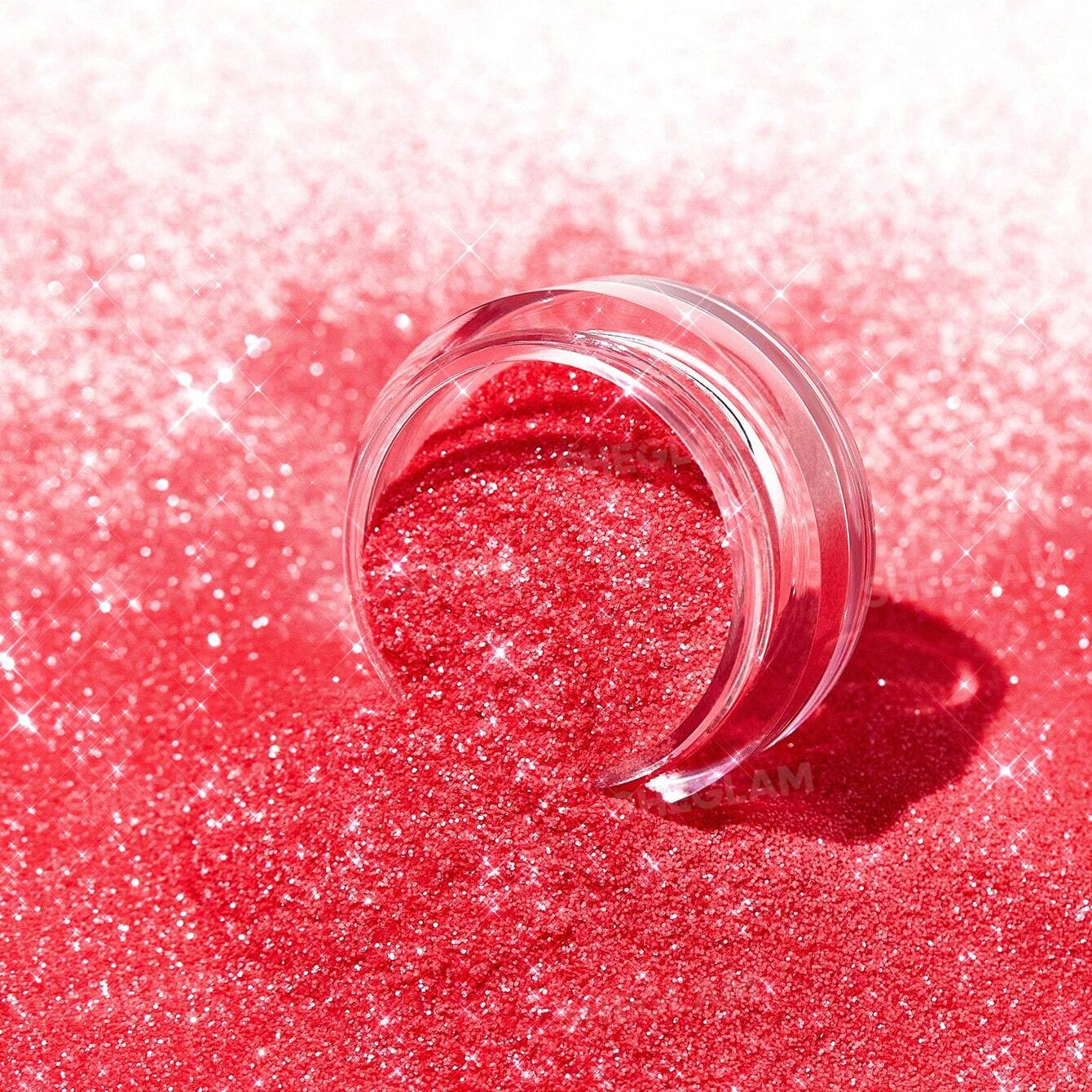 Small clear container on a red glittery surface