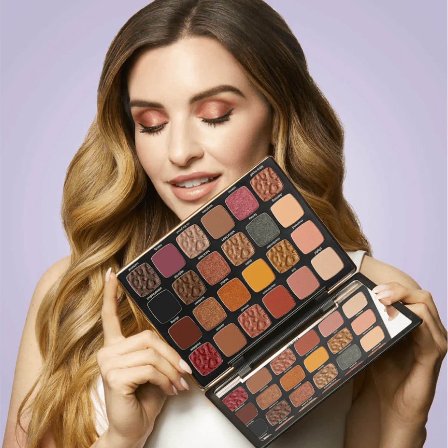 a beautiful girl holding Tarte After Dark Eyeshadow Palette for her available at Heygirl.pk for delivery in Pakistan. 