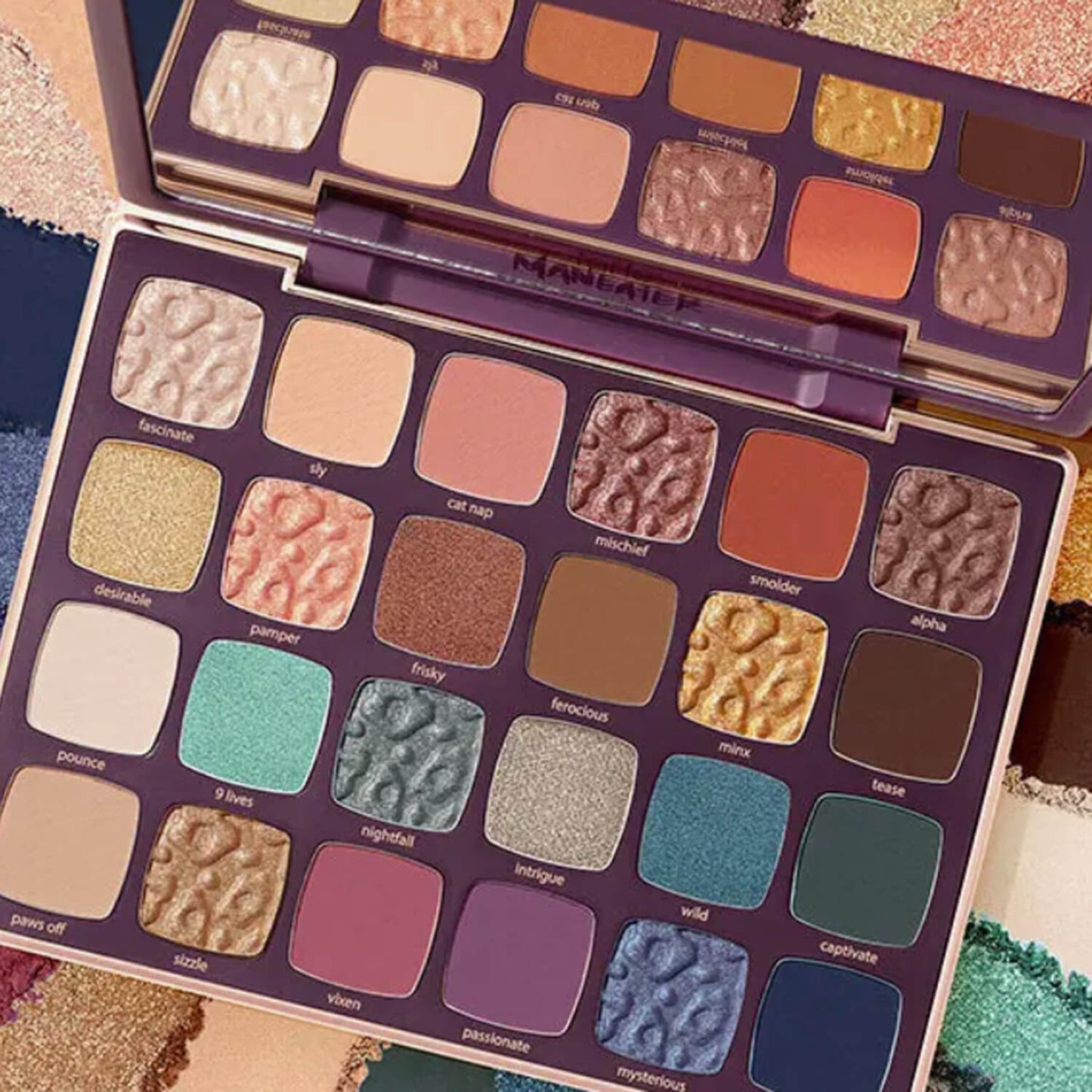 Makeup palette with various colors on a textured surface